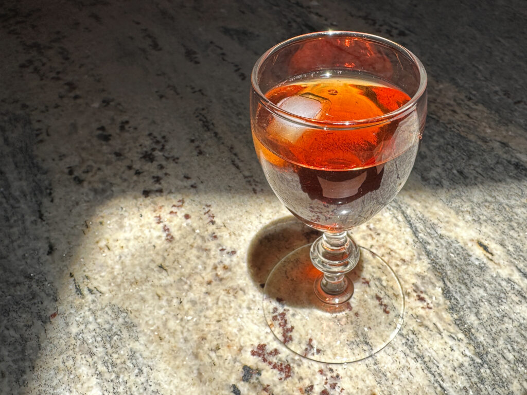 glas with rose hip liqueur